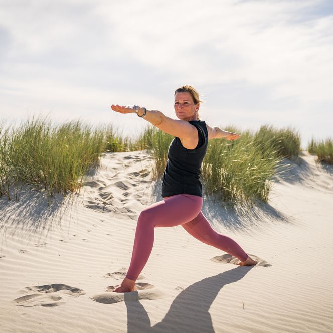 Frau beim Yoga in den Dünen auf Borkum