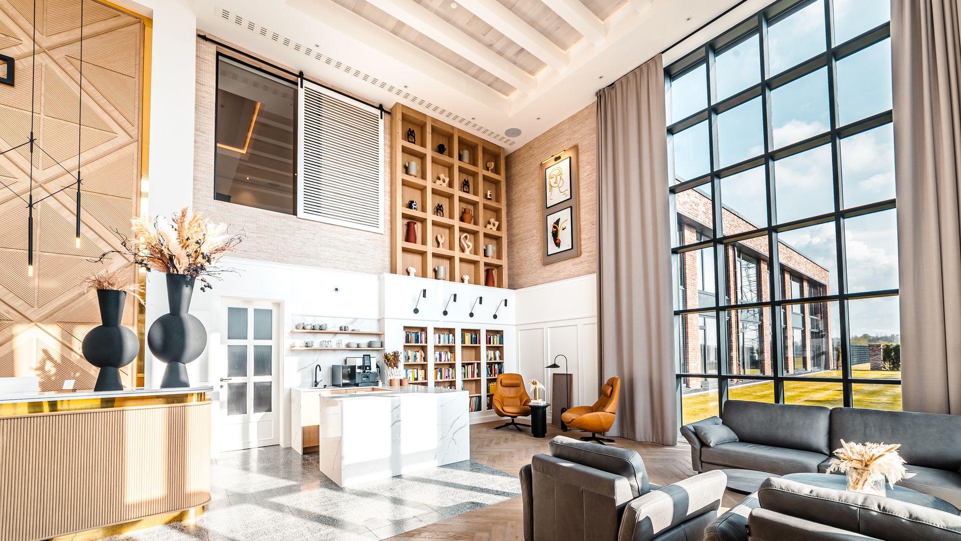 Helle Hotellobby mit hohen Fenstern, modernen Sitzmöbeln und stilvollen Dekorationselementen