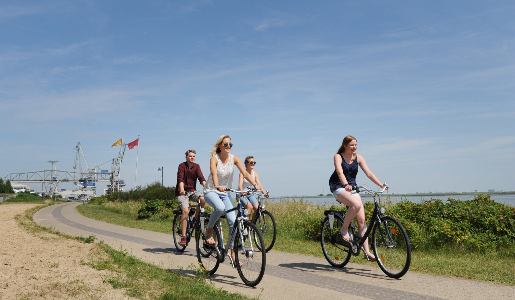 Rad fahren, Fahrrad fahren, Fahrrad, Gruppe, Promenade, Wasser, Weser, Nordenham, © Touristgemeinschaft Wesermarsch/ Meike Lücke