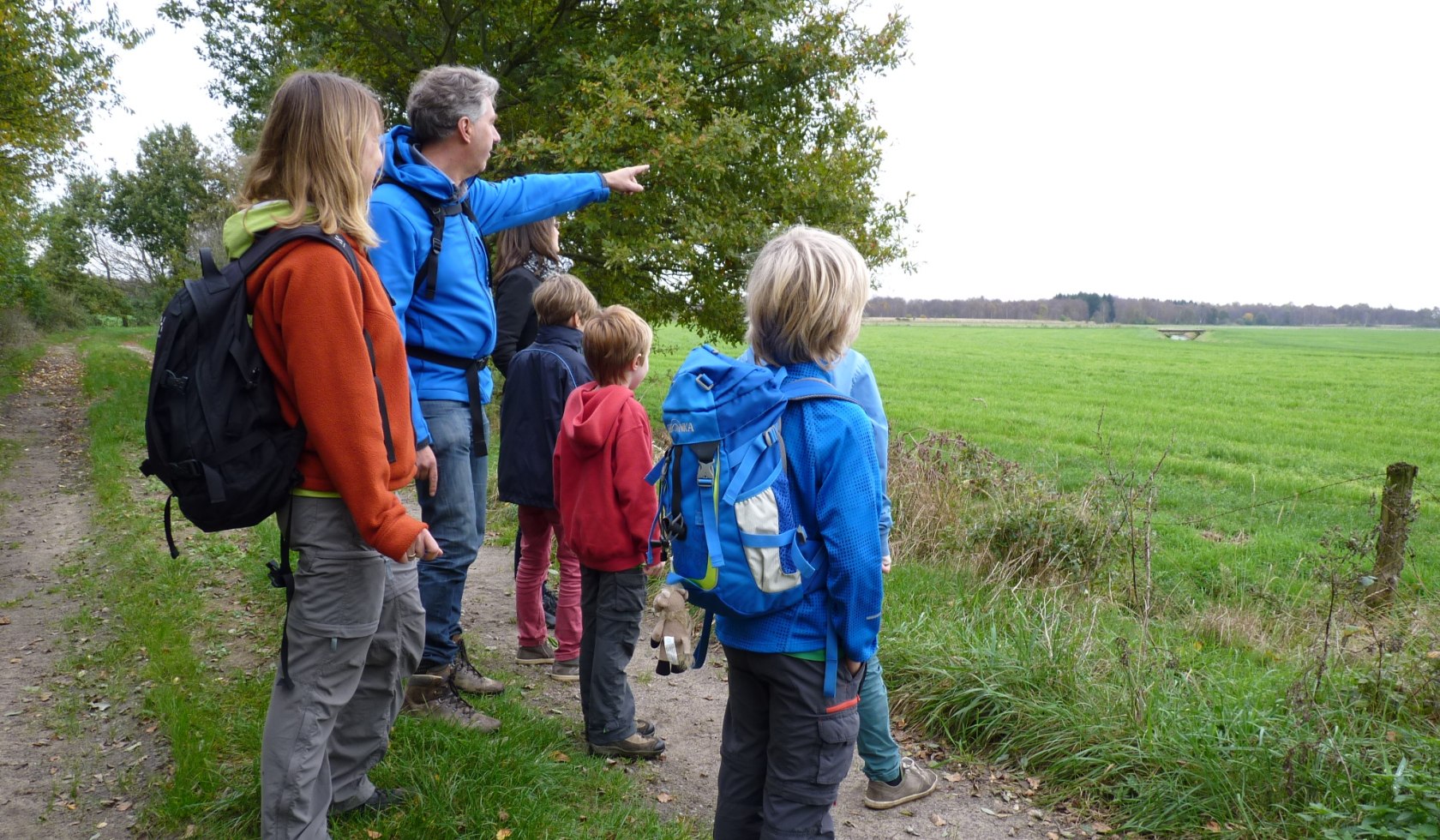 Erwachsene und Kinder stehen an der Weide und scheinen Kraniche entdeckt zu haben., © Touristikverband Landkreis Rotenburg (Wümme)